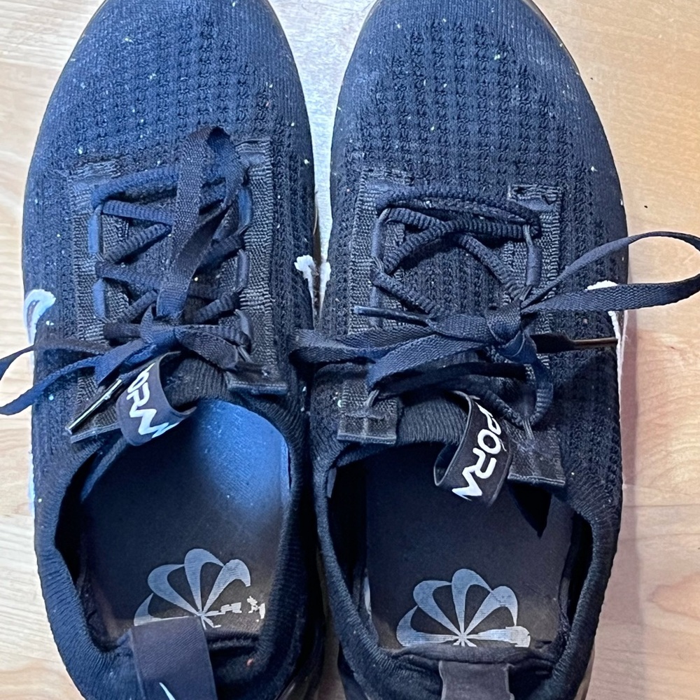 Kids black Nike shoes